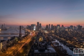 De skyline panorama van Rotterdam tijdens zonsondergang