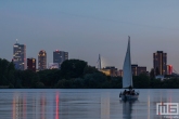 Te Koop | Het uitzicht op de skyline van Rotterdam met een zeilboot op de Kralingseplas