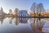 Te Koop | Het Veerhuis en de Grote Kerk in Rotterdam Overschie in de sneeuw